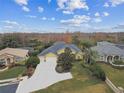 Aerial view of a well-maintained home, showcasing lush landscaping and a spacious driveway at 2126 Larchwood Ct, Trinity, FL 34655