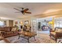 Spacious living room featuring hardwood floors, a fireplace, and ample natural light at 2241 Heron Circle, Clearwater, FL 33762