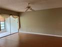 Spacious living room with wood-look floors and ceiling fan at 2251 Spruce Ln # A, Palm Harbor, FL 34684