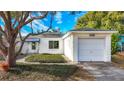 House exterior showcasing a white single-story home with attached garage at 229 Lime S Cir, Dunedin, FL 34698