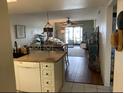 Kitchen island and open floor plan with access to living area at 25225 Rampart Blvd # 1902, Punta Gorda, FL 33983