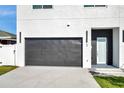 New construction home with a sleek, black garage door at 2608 W Columbus Dr # 5, Tampa, FL 33607