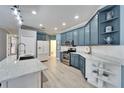 Spacious kitchen with light blue cabinets and quartz countertops at 302 Latitude Pl, Apollo Beach, FL 33572