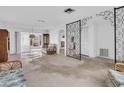 Spacious living room features a decorative room divider and lots of natural light at 3220 Salisbury Dr, Holiday, FL 34691