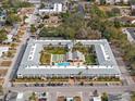 Aerial view showing apartment building with pool and surrounding area at 4746 Azalea Dr # 105C, New Port Richey, FL 34652