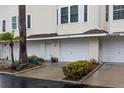 Tan building with white garage doors and landscaping at 9341 Blind Pass Rd, St Pete Beach, FL 33706