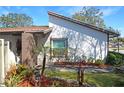 Close up of home's architecture, showcasing landscaped garden, a brick wall and walkway at 10303 Chadbourne Dr, Tampa, FL 33624