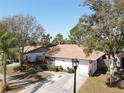 Aerial view of a cozy one-story home featuring a well-manicured lawn and a two-car garage at 10303 Chadbourne Dr, Tampa, FL 33624