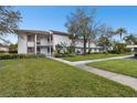 Condo building exterior with walkway and landscaping at 130 Lakeview Way # 130, Oldsmar, FL 34677