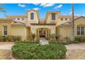 Front view of a two-story home with walkway at 1354 Emerald Dunes Dr, Sun City Center, FL 33573