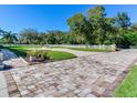 Landscaped yard with brick pavers and a white fence at 1503 Limona Rd, Brandon, FL 33510