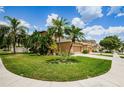 Landscaped yard with palm trees and a two-story house at 17443 Glenapp Dr, Land O Lakes, FL 34638