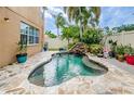 Freeform pool with stone deck and waterfall feature at 17443 Glenapp Dr, Land O Lakes, FL 34638