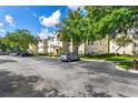 View of apartment building with parking lot and landscaping at 18119 Sterling Gate Cir # 18119, Tampa, FL 33647