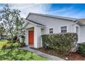 Bright red door and well-manicured landscaping at 20922 Jaffa Ln, Land O Lakes, FL 34637