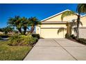 Front exterior showcasing a two-car garage and landscaping at 2501 Sapphire Greens Ln, Sun City Center, FL 33573