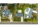 Overhead view of two homes and properties, including backyard patio and boat at 608 Florida Blvd, Crystal Beach, FL 34681