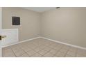 Image shows a basement space with tiled floor and access door to utility panel at 6210 92Nd N Pl # 3405, Pinellas Park, FL 33782