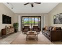 Living room featuring leather furniture, a TV, and a sliding glass door to the porch at 6210 92Nd N Pl # 3405, Pinellas Park, FL 33782