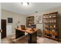 Office with wooden desk, shelves, laptop and a rug on tile floors at 6210 92Nd N Pl # 3405, Pinellas Park, FL 33782