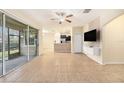 Open living area with tile floors, kitchen island, and sliding glass doors at 8110 Hampton View Ln, Tampa, FL 33647
