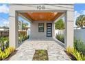 Covered entryway with wood ceiling and gray brick pavers at 108 E Chelsea St, Tampa, FL 33603