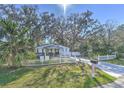 Charming house with a white picket fence and lush landscaping at 11121 Roberts Ln, Riverview, FL 33578