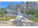 Cute bungalow with white picket fence and spacious driveway at 11121 Roberts Ln, Riverview, FL 33578