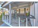 Quaint front porch with wicker furniture, perfect for relaxing at 11121 Roberts Ln, Riverview, FL 33578