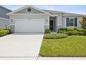 Two-car garage and well-maintained front yard at 12772 Achasta Blvd, Hudson, FL 34669