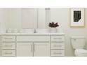 Modern bathroom with white vanity, quartz countertop, and a toilet at 13078 Ruby Gold Ct, Wimauma, FL 33598