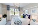 Guest bedroom with window seat and decorative pillows at 14952 Serene Shores Loop, Lakewood Ranch, FL 34211