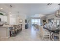 Open concept kitchen and dining area with island and breakfast bar at 14960 Serene Shores Loop, Bradenton, FL 34211