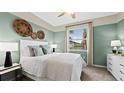 Charming bedroom with light green walls, a comfortable bed, and large window at 15053 Sea Salt Way, Bradenton, FL 34211