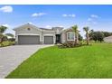 New construction home with gray siding and stone accents at 15143 Sea Salt Way, Bradenton, FL 34211