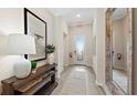 Bright and airy foyer with tile flooring and decorative accents at 15218 Serene Shores Loop, Bradenton, FL 34211