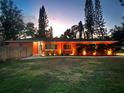 Attractive coral house exterior, illuminated at night at 1530 Rollen Rd, Clearwater, FL 33755