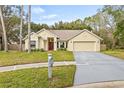 Updated single story home with a two-car garage and landscaped lawn at 16104 Stowe Ct, Tampa, FL 33647