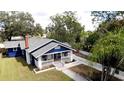 Blue house with gray roof, white trim, and a porch, showcasing curb appeal at 1815 2Nd E Ave, Bradenton, FL 34208