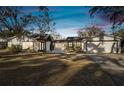 Charming single story home with white siding, two-car garage, and well-manicured lawn at 18803 15Th St, Lutz, FL 33549