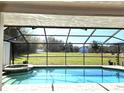 Inviting pool and spa area with screened enclosure and open backyard at 3009 Jim Johnson Rd, Plant City, FL 33566