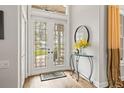 Bright and airy foyer with glass doors and a decorative console table at 4339 Cheval Blvd, Lutz, FL 33558