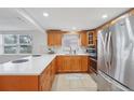 Modern kitchen with light wood cabinets and white countertops at 4549 Madison St, New Port Richey, FL 34652