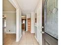 Bright and spacious entryway with tile floors and a view of the kitchen at 4920 Steel Dust Ln, Lutz, FL 33559