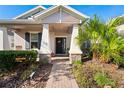 Front porch with brick walkway, palm trees, and rocking chair at 5149 Jennings Trl, Brooksville, FL 34601