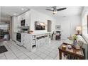 Modern white kitchen with breakfast bar and stainless steel appliances at 5267 81St N St # 12, St Petersburg, FL 33709