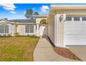 Front entry of the house with walkway, landscaping, and a charming archway at 6119 Freeport Dr, Spring Hill, FL 34606