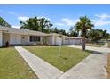 Landscaped front yard with mature trees and walkway leading to the house at 7304 Gates Cir, Spring Hill, FL 34606