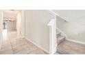 Interior view of a staircase and hallway with tile flooring at 7610 Blue Iris Ln, Tampa, FL 33619