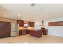 Modern kitchen featuring stainless steel appliances and ample cabinetry at 8310 Archwood Cir, Tampa, FL 33615